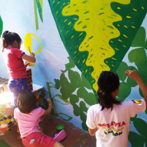 Kids painting a mural